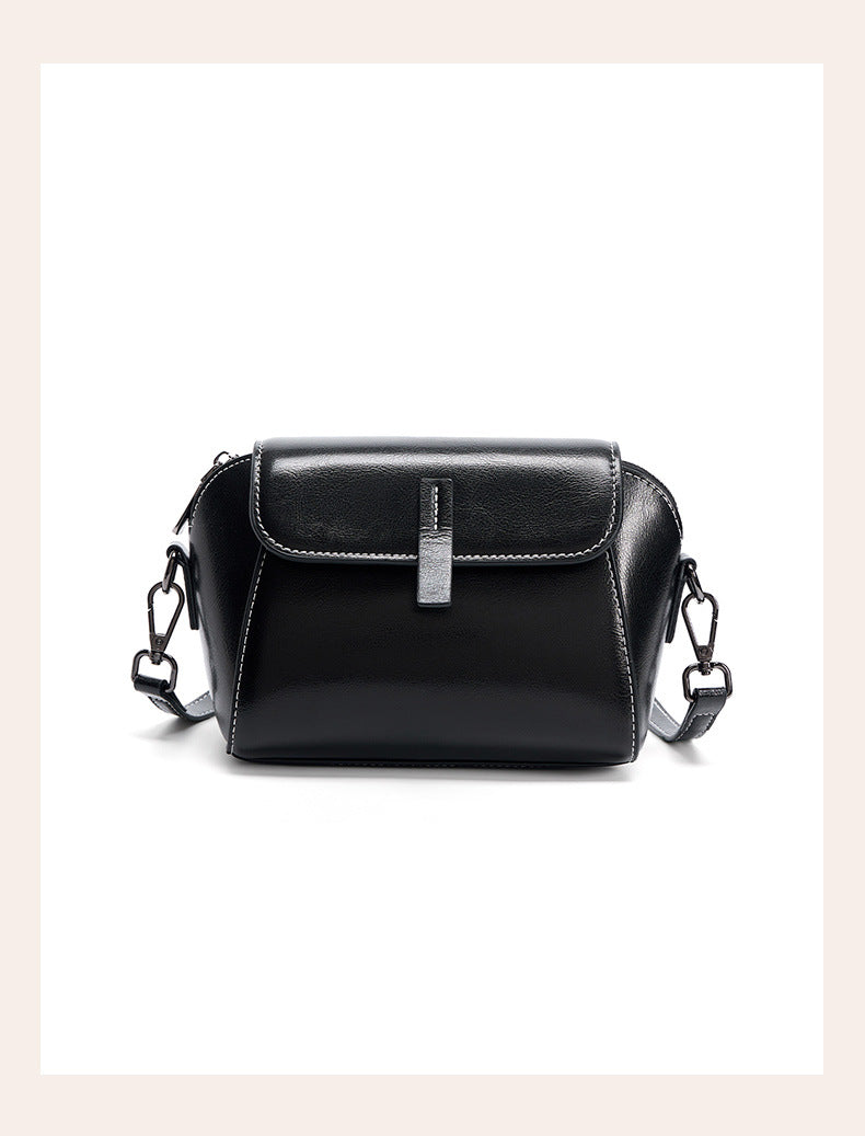 Front view of black leather crossbody bag with silver-tone strap clips