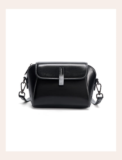 Front view of black leather crossbody bag with silver-tone strap clips