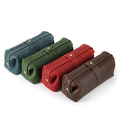 Four leather cosmetic pouches in blue green red and brown