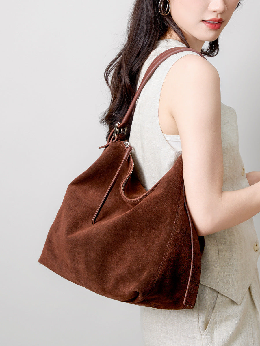 Close view of the soft brown bag worn over the shoulder