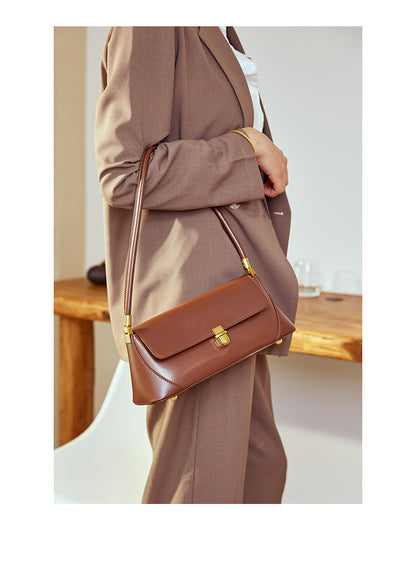 Coffee baguette bag styled with beige blazer and trousers