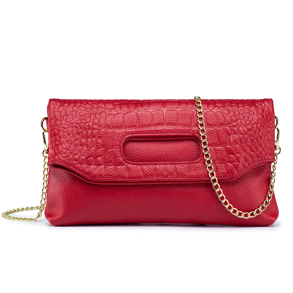 Red envelope clutch with embossed panels and detachable chain strap