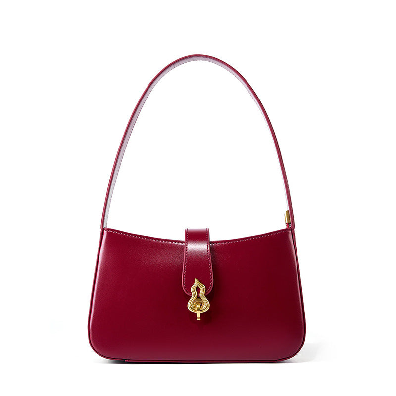 Burgundy cowhide leather shoulder bag with gourd lock clasp on white background