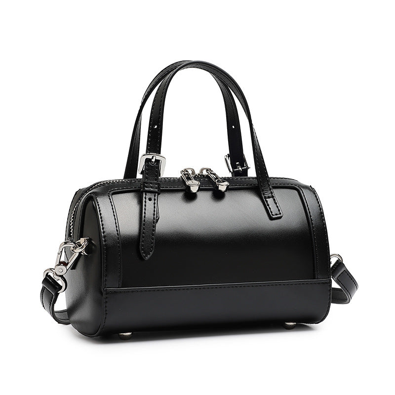 Black cowhide leather mini Boston bowling bag with top handles and silver-tone hardware