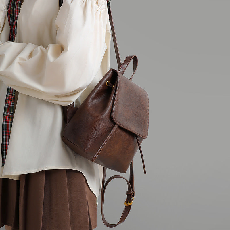 Vintage brown split cowhide backpack shown on a model