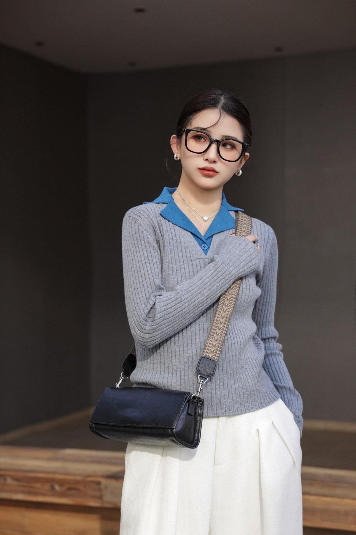 Black shoulder bag photographed in profile