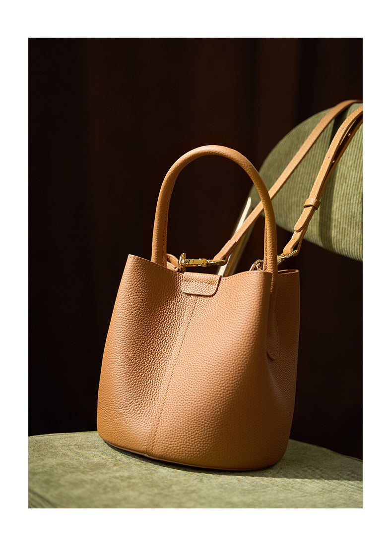 Biscuit bucket bag close-up showing pebbled leather texture and center seam
