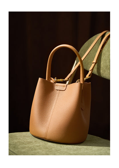 Biscuit bucket bag close-up showing pebbled leather texture and center seam