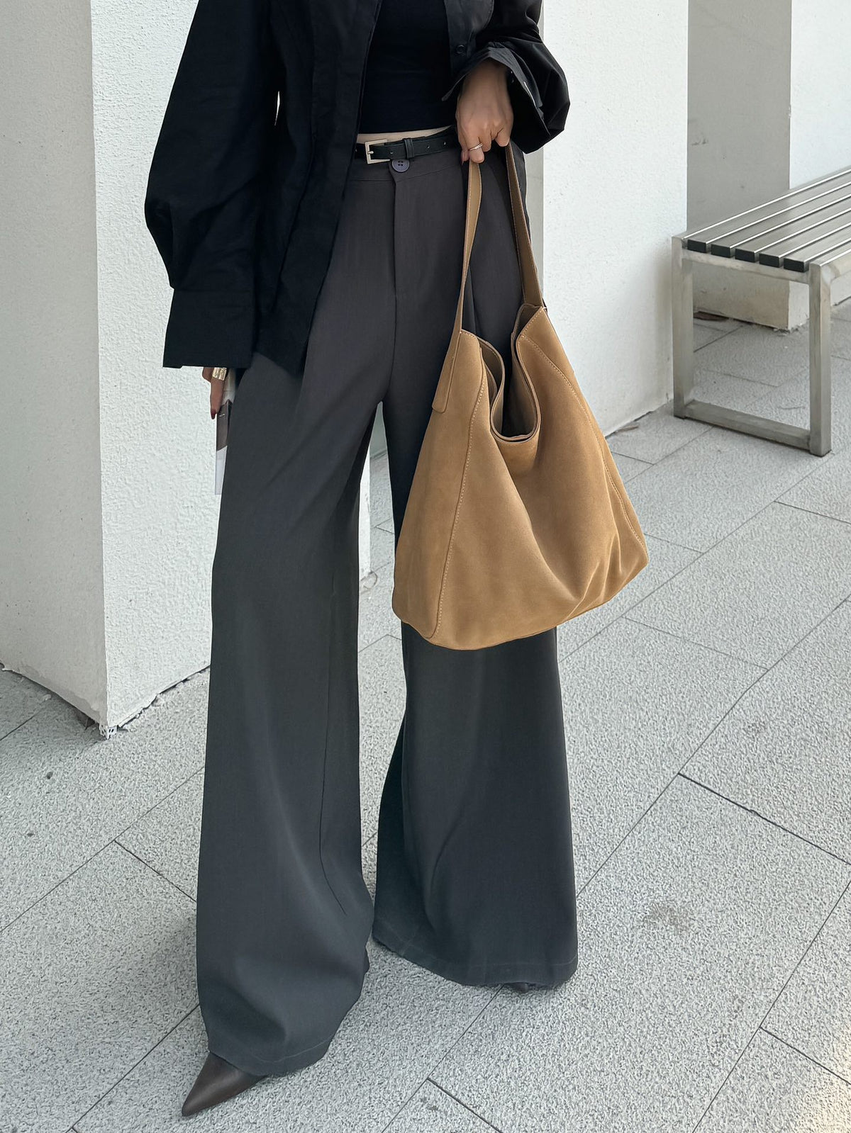 Model carrying the caramel shoulder tote outdoors