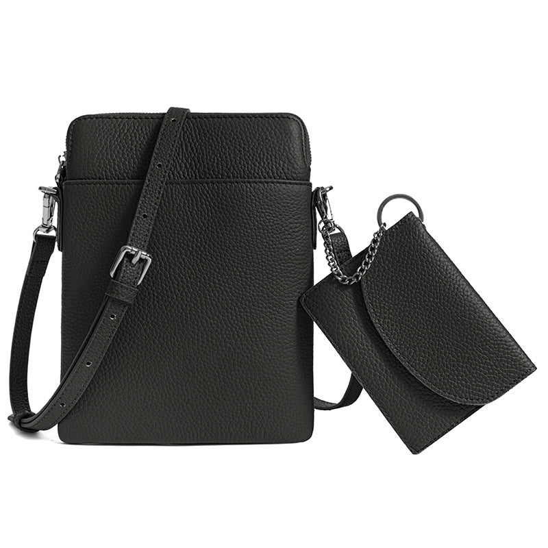 Black pebbled leather mini crossbody phone bag with matching detachable coin pouch on white background