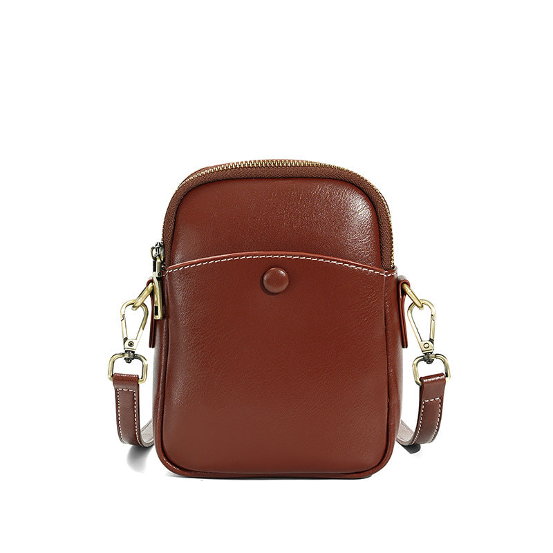 Caramel brown cowhide leather mini crossbody bag with zip top closure