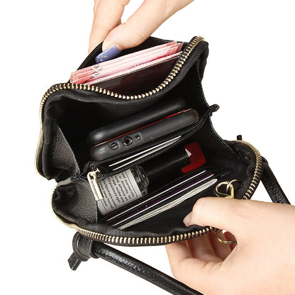 Interior view of black crossbody phone bag showing card slots, zip pocket, and compartments