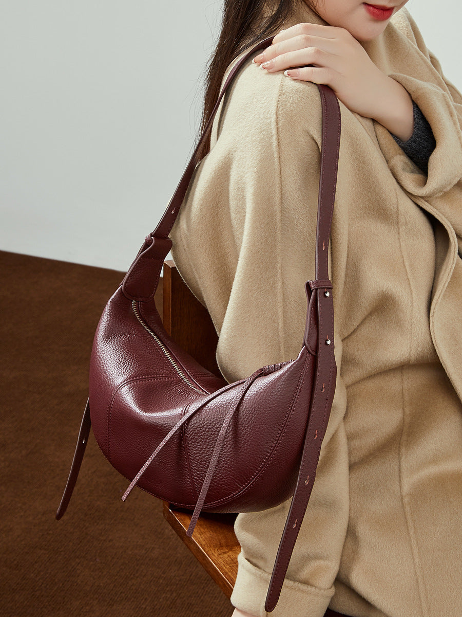 Wine red cowhide hobo bag styled with camel coat