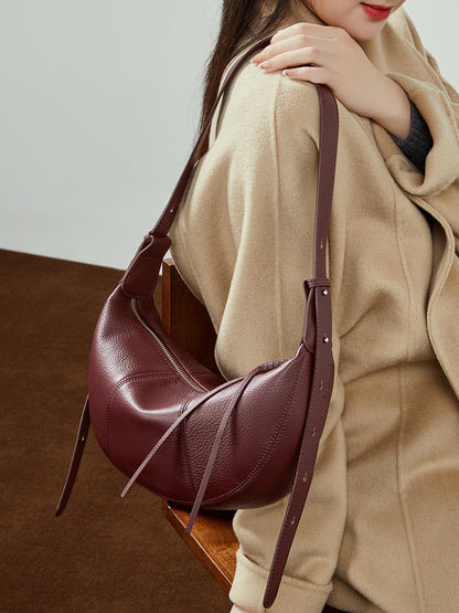 Wine red cowhide hobo bag styled with camel coat