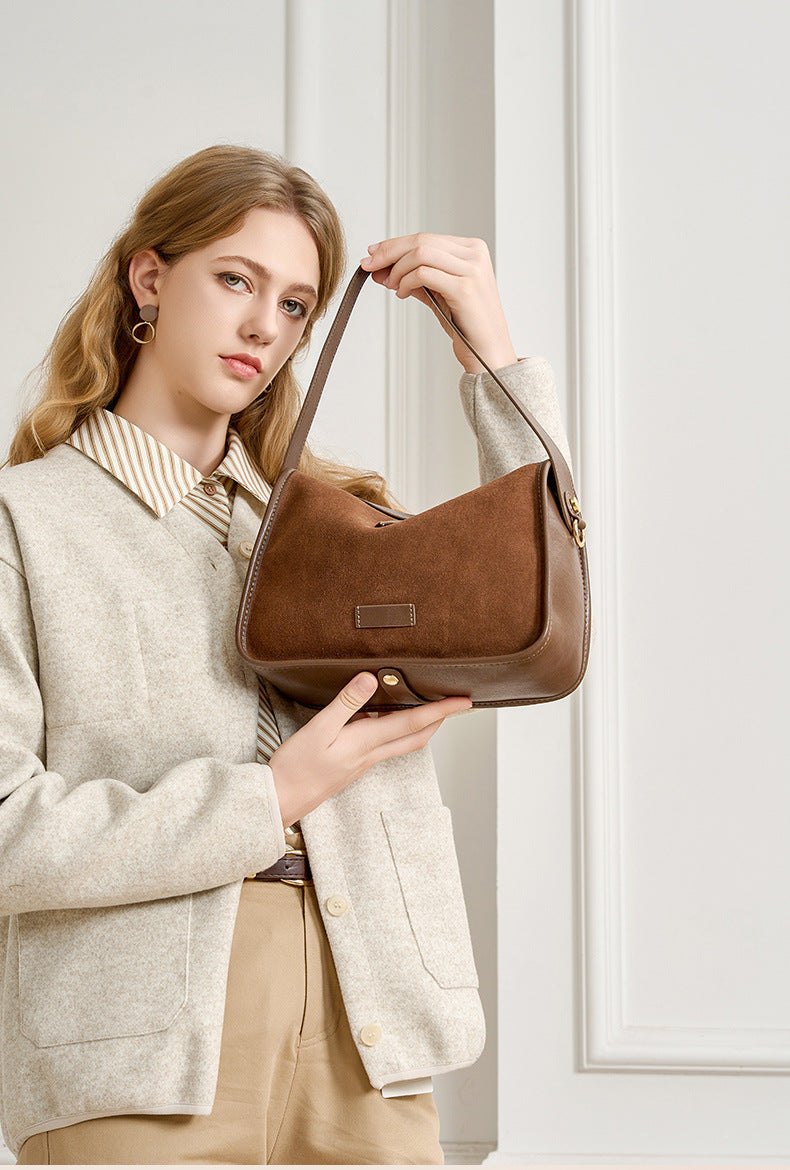Front view of a medium suede cowhide crossbody bag in a warm brown shade