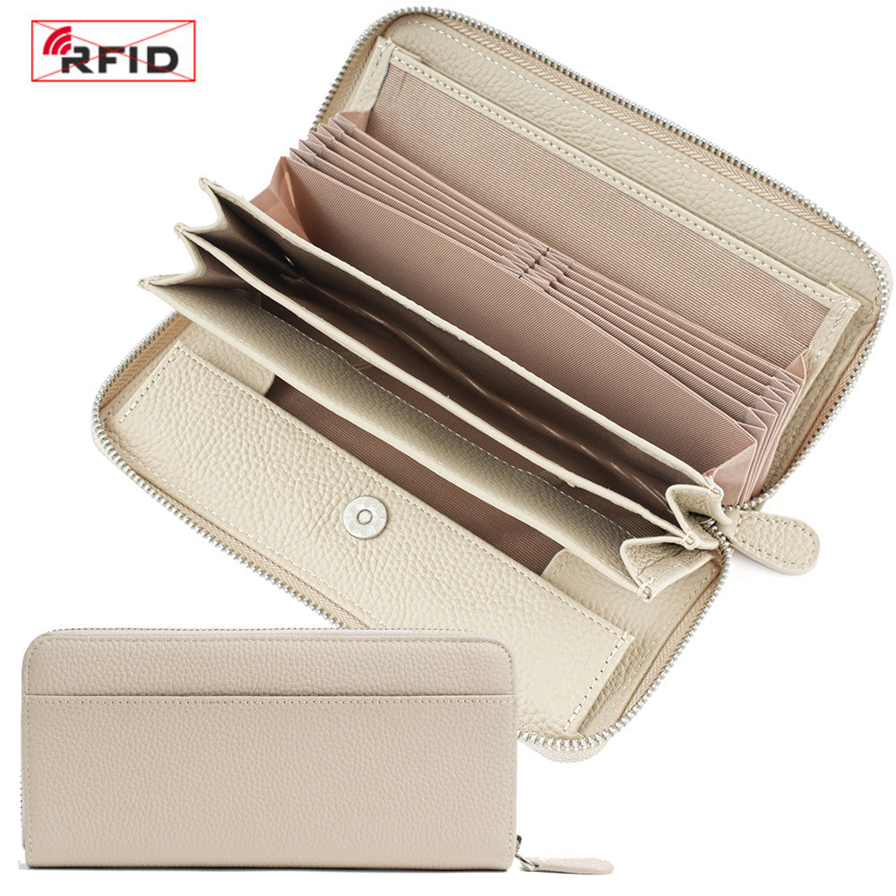 Open ivory wallet displaying card slots, bill compartments, and coin pocket