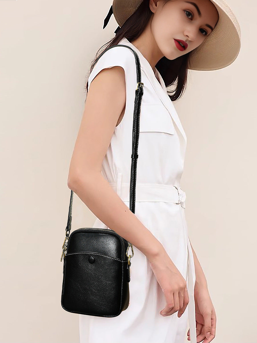 Model wearing black cowhide leather mini crossbody bag with white outfit