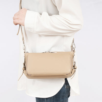 Black leather bag displayed on model in casual outfit