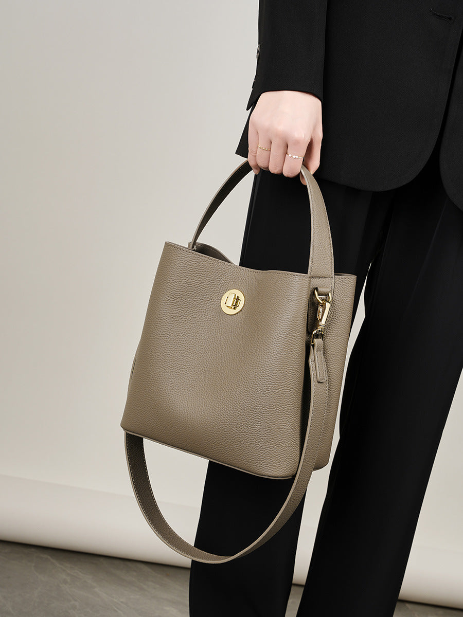 Khaki bucket bag styled with black blazer for everyday wear