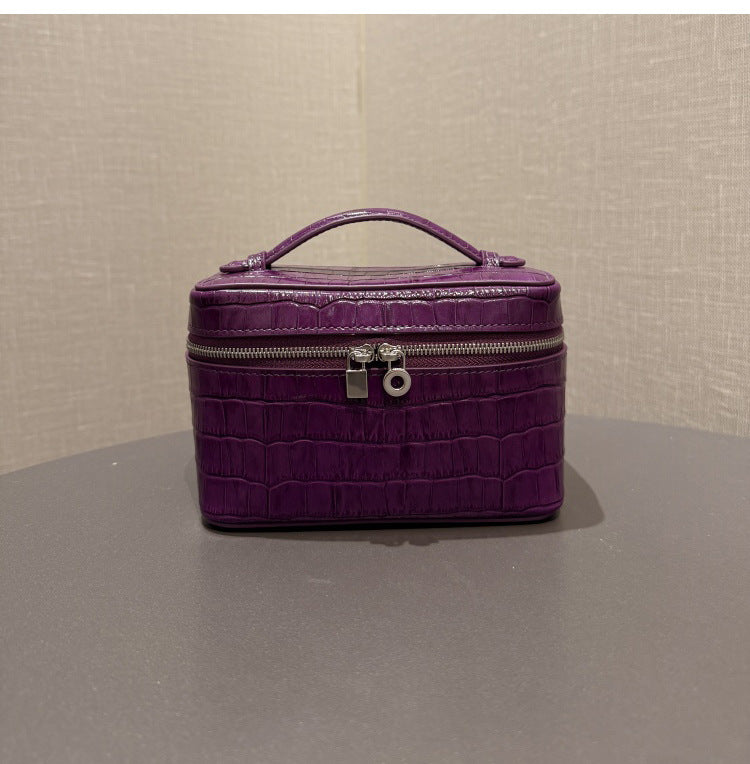Open purple pouch showing divided compartments and interior zip pocket