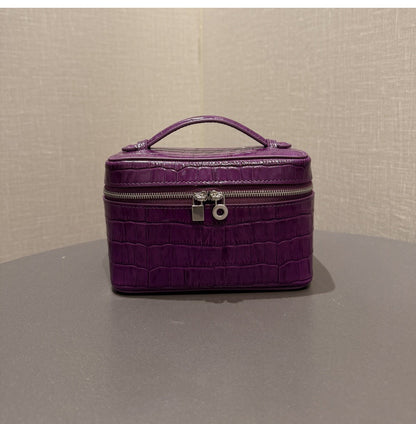 Open purple pouch showing divided compartments and interior zip pocket