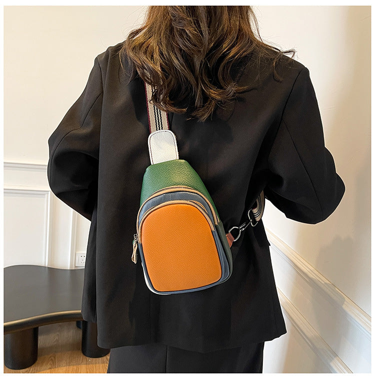 Back view of orange-front leather sling bag