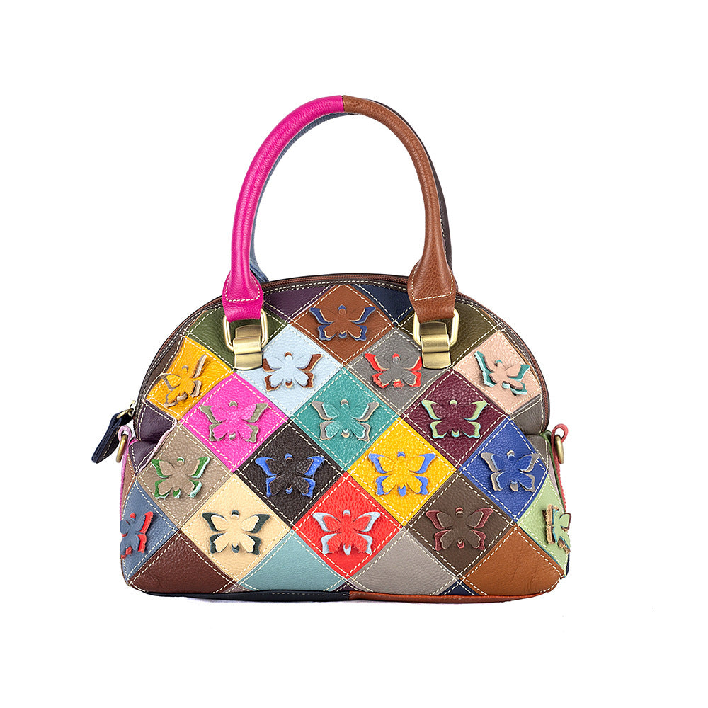 Front view of colorful cowhide shell bag with raised butterfly and flower patchwork