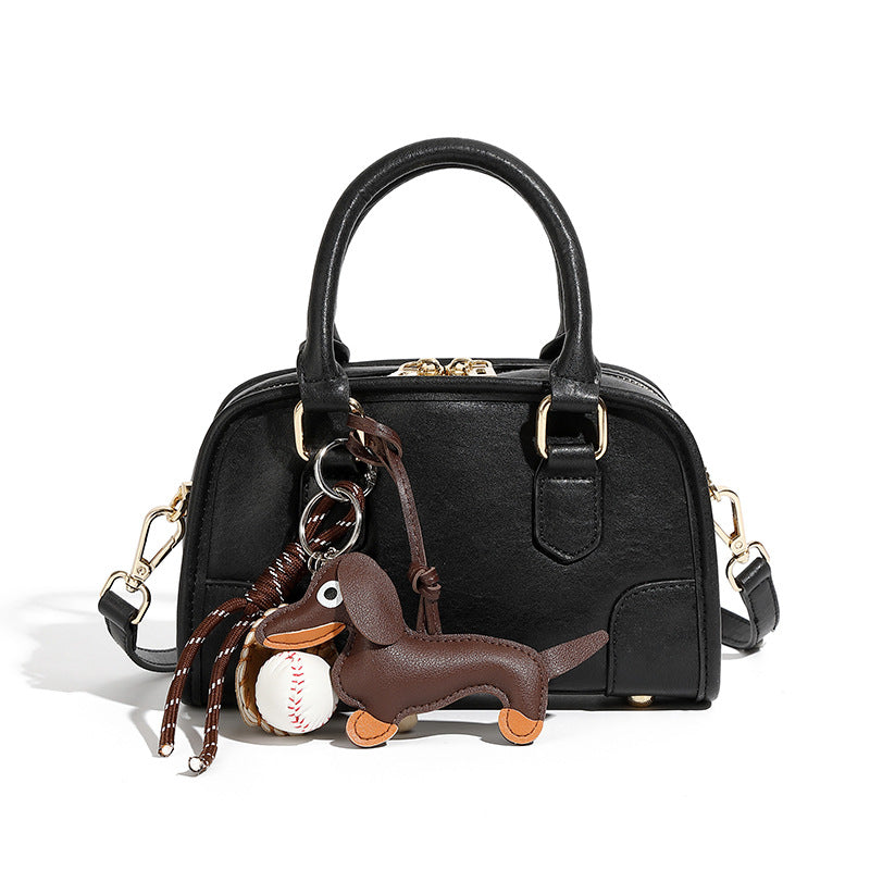 Black split leather mini bowling bag with gold-tone hardware and charms