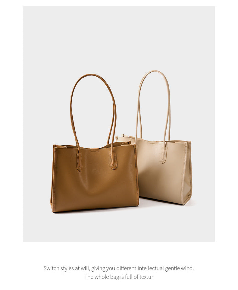 Two leather tote bags in golden brown and salt beige shown side by side