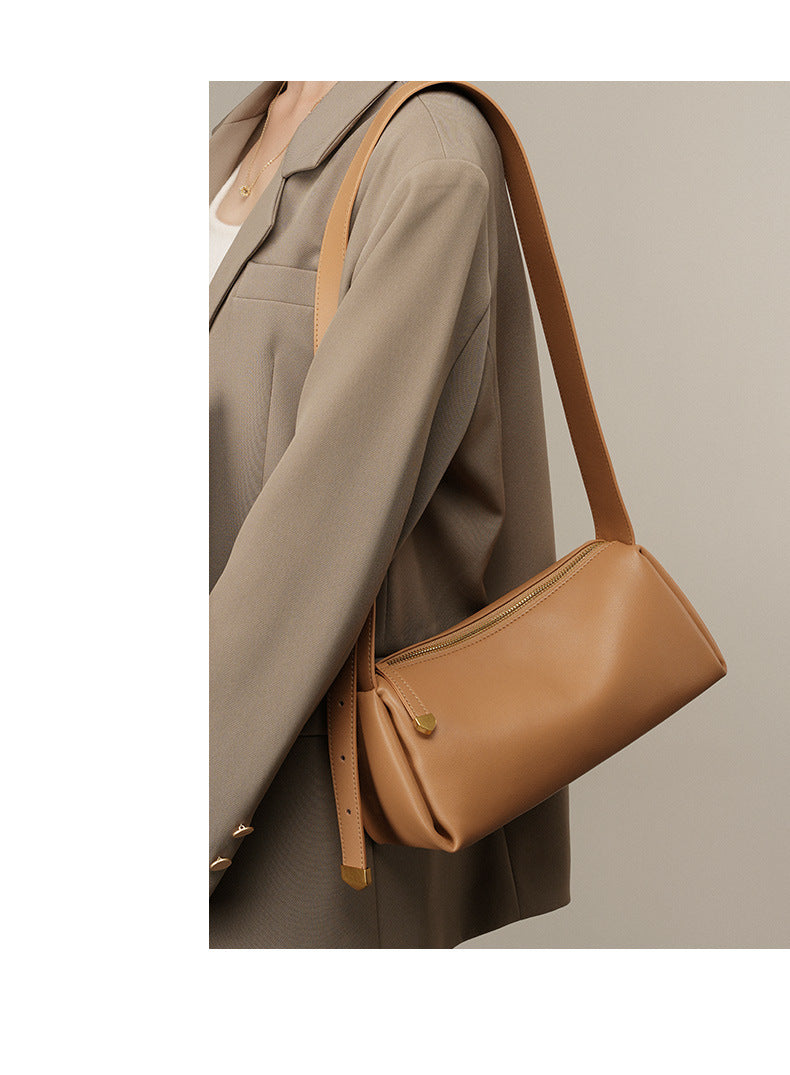 Apricot pillow crossbody bag styled with a beige blazer