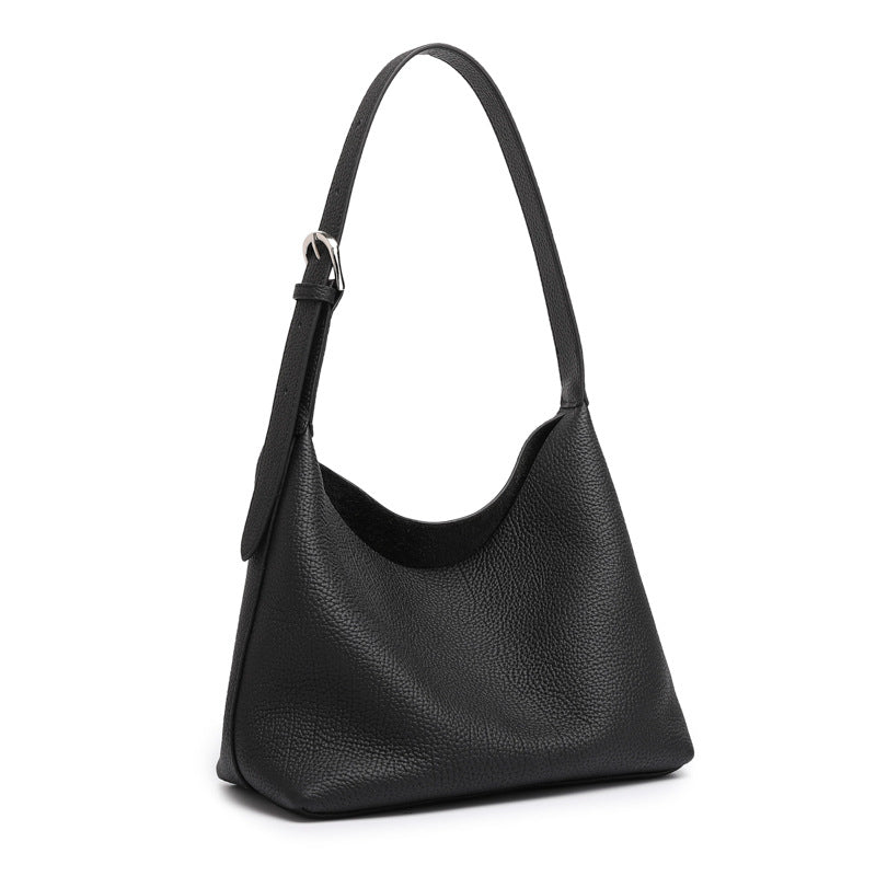 Black pebbled cowhide hobo bag with adjustable shoulder strap on white background