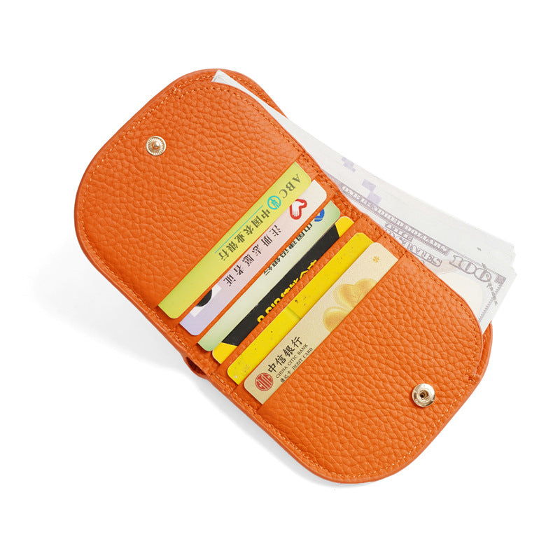 Orange pebbled cowhide leather bifold wallet open showing six card slots and bill compartment