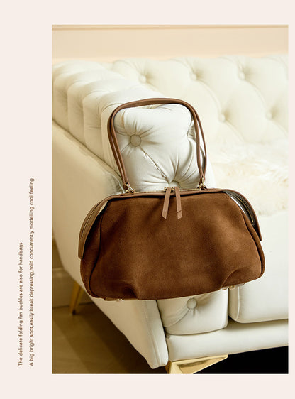 Two brown and coffee shoulder bags styled on a sofa