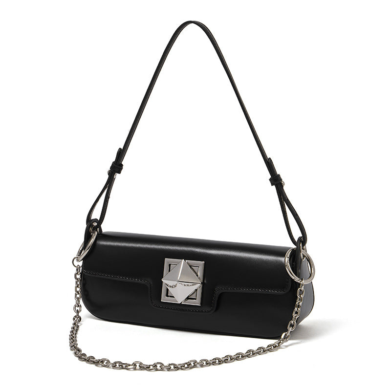 Black leather baguette shoulder bag with geometric hardware on white background
