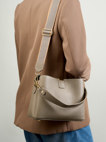 Back view of the brown leather bag worn on the shoulder