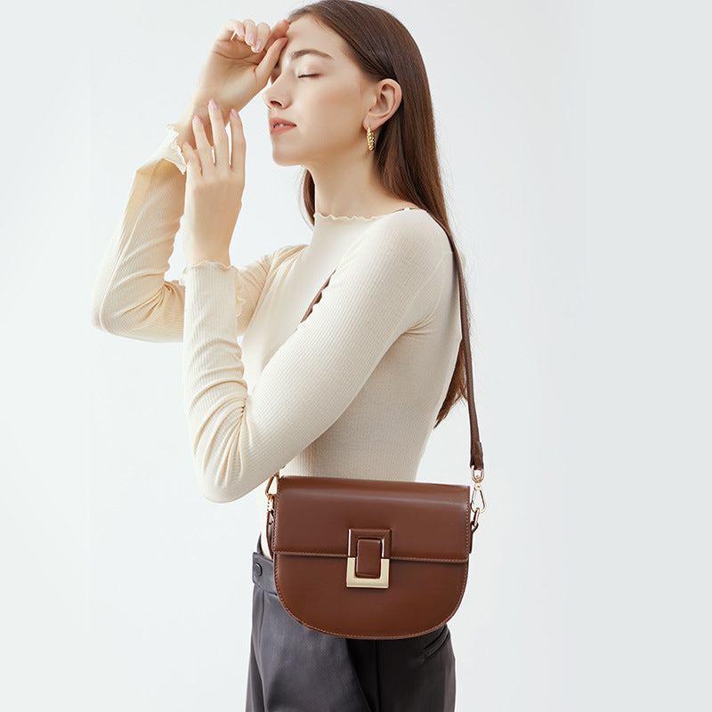 Brown saddle bag worn on the shoulder, side styling view