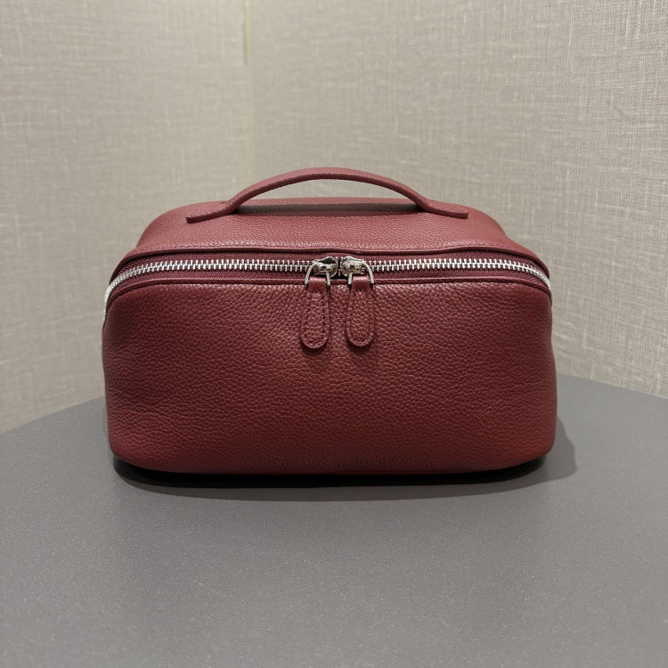 Burgundy top-grain cowhide cosmetic pouch with zip closure and carry handle