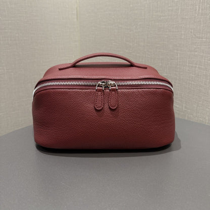 Burgundy top-grain cowhide cosmetic pouch with zip closure and carry handle