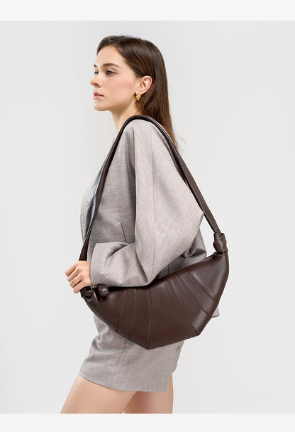 Side view of model with coffee crescent bag worn as crossbody