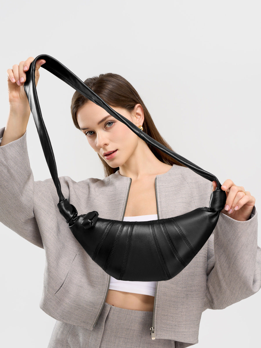 Model wearing black crescent bag as shoulder carry in gray linen set