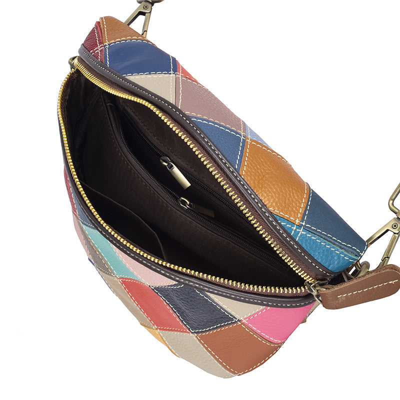 Open crossbody bag showing zip divider and interior pockets