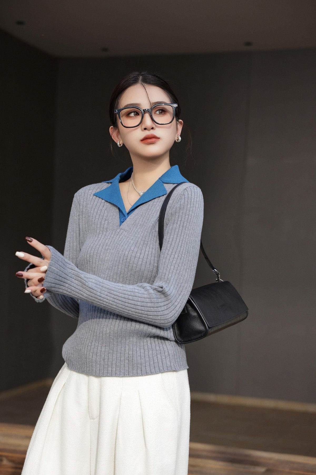 Black bag worn at the shoulder in a lifestyle portrait