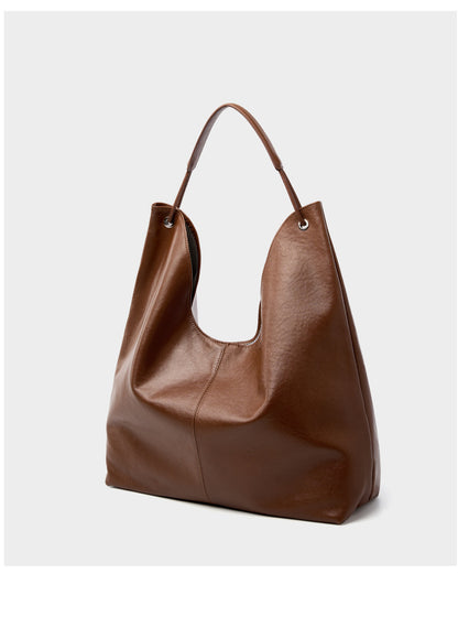 Brown hobo tote bag angled front view on light gray background