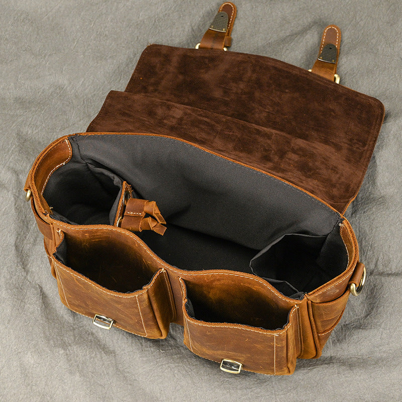 Open camera bag showing polyester-lined interior and dividers