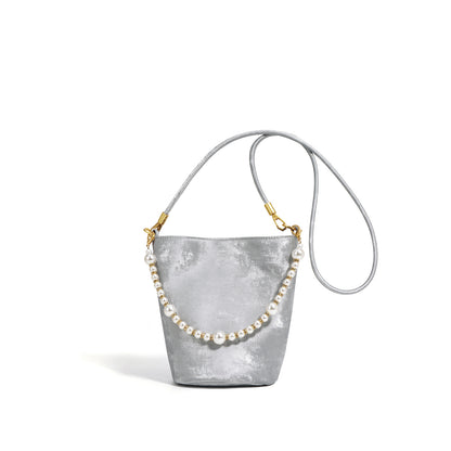 Silver gray mini bucket bag with pearl chain and long strap on white background