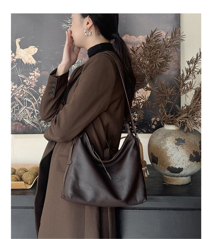 Havana leather bag on a model in an interior setting
