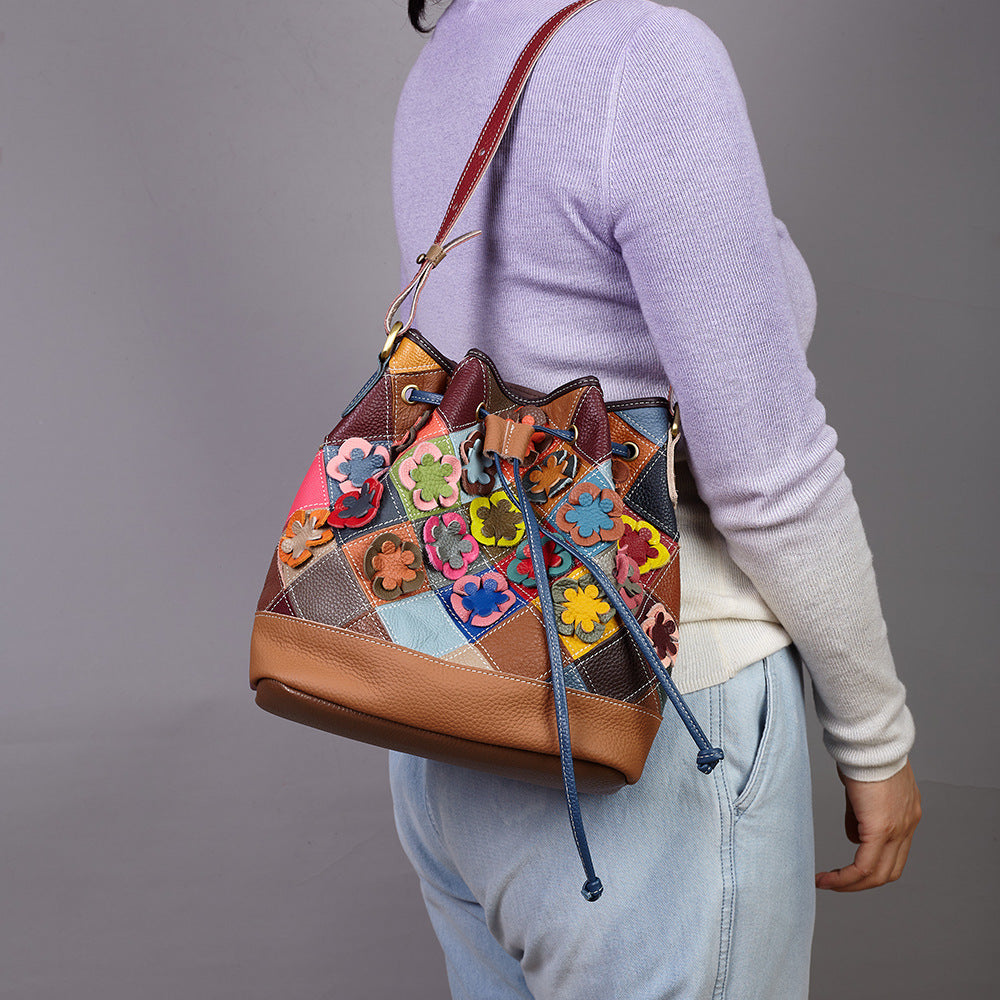 Floral cowhide bucket bag worn over the shoulder