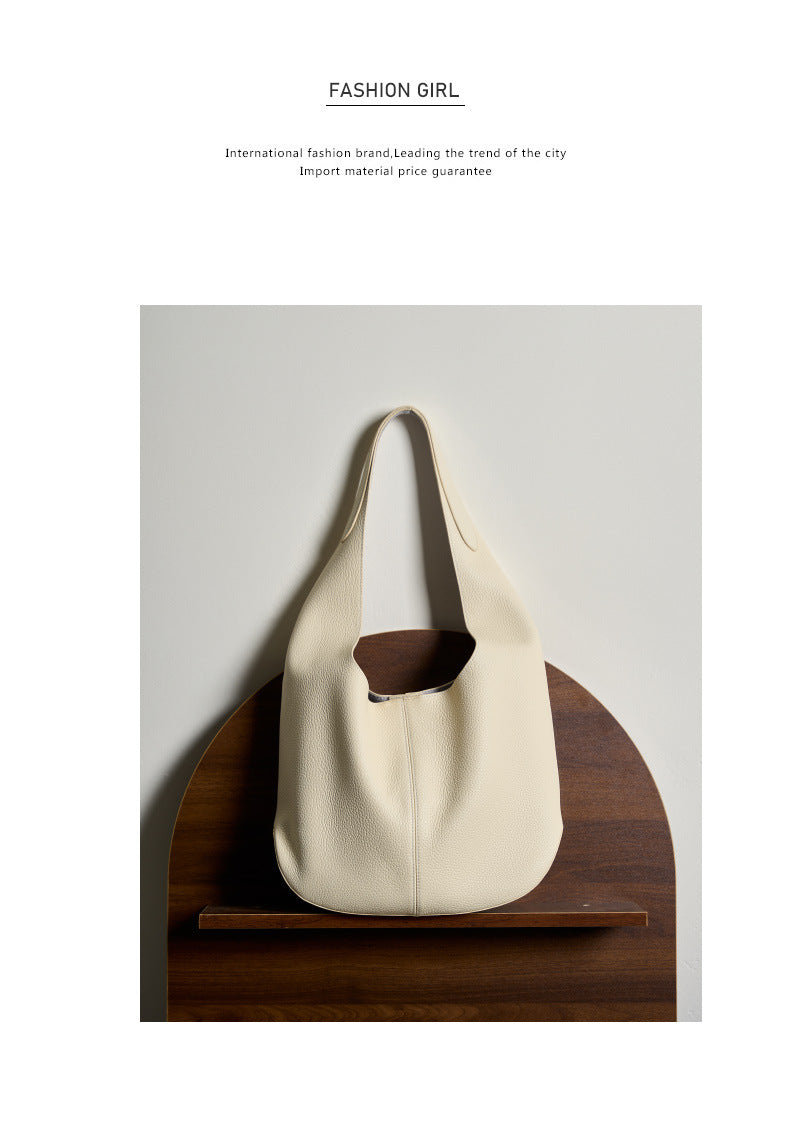 Off-white bucket tote displayed on a wooden shelf