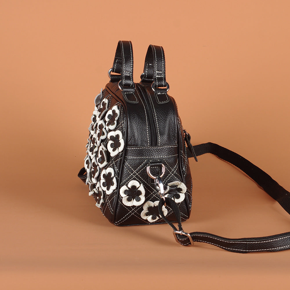 Side profile showing the bag depth, top handles, and shoulder strap