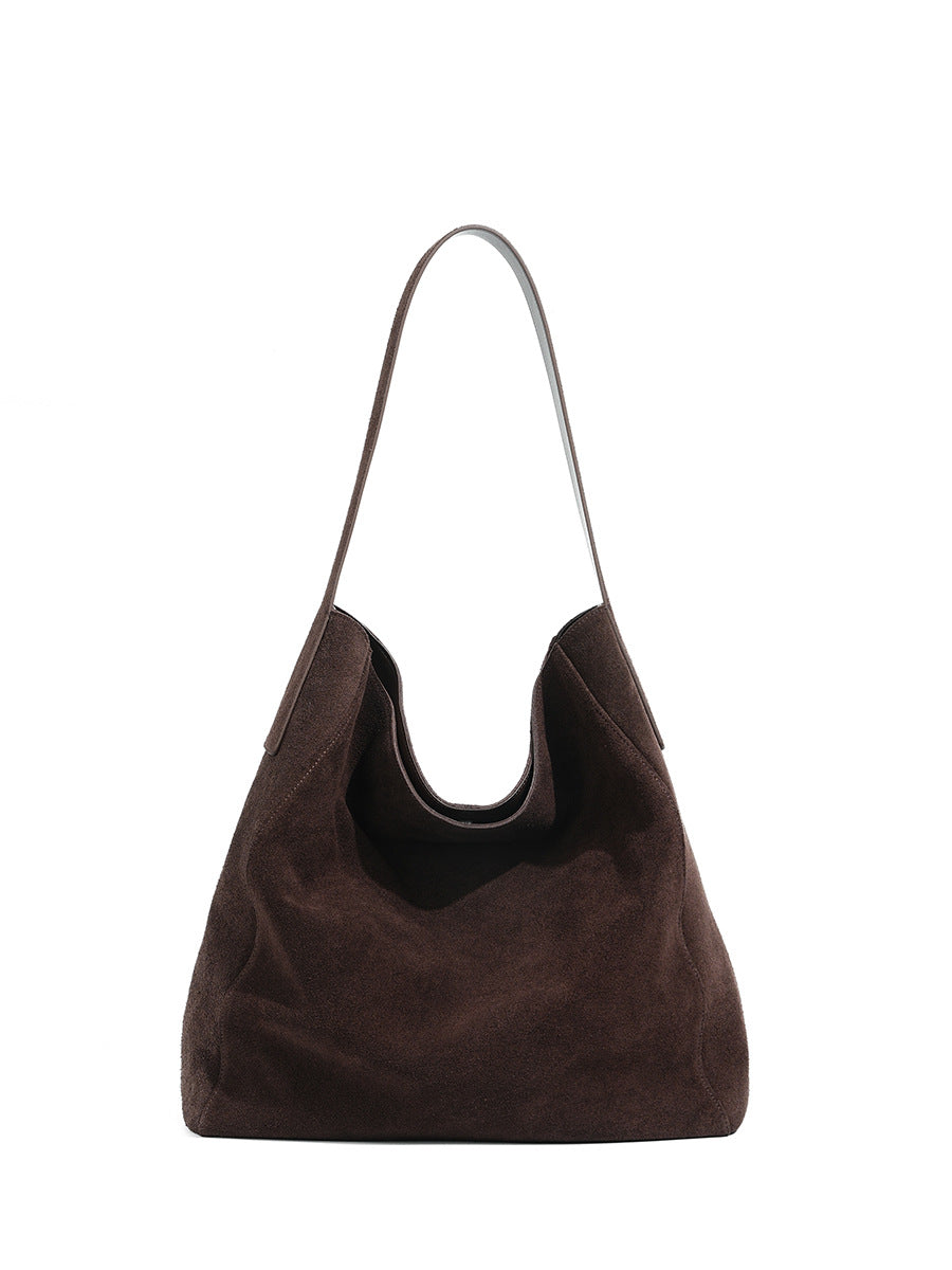 Front view of the ebony suede tote and its long shoulder strap